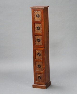 A pedestal cabinet enclosed by a pair of panelled doors in the form of a 6 drawer chest 98cm h x 19cm w x 19cm d (damage to top right hand side) 