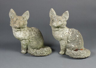 A pair of well weathered concrete garden figures of seated foxes 30cm h x 30cm w x 18cm d 