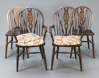 A set of 6 beech framed wheelback dining chairs comprising 2 carvers 96cm h, 4 standard 88cm h, on turned supports with H framed stretchers (some contact marks and scratches)  