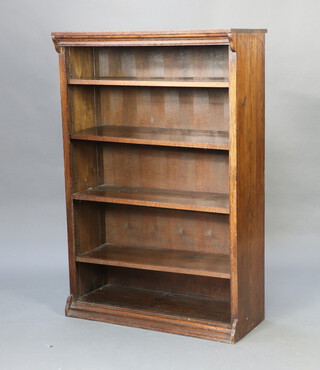 An oak bookcase fitted adjustable shelves raised on a platform base 137cm h x 91cm w x 38cm d 