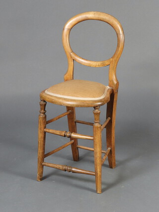 A Victorian bleached mahogany balloon back childs training chair with upholstered seat, raised on turned supports 83cm h x 35cm x 34cm d (seat 21cm x 21cm, frame loose, sun bleached) 