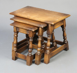 A nest of 3 rectangular oak interfitting coffee tables, raised on turned and block supports 46cm h x 60cm w x 31cm d (water marks in places) 