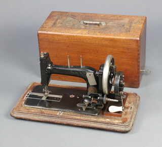 A German manual sewing machine complete with carrying case, (case showing signs of old but treated worm)  