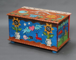 A rectangular painted pine toy trunk with hinged lid 49cm h x 89cm w, raised on bun feet (1 bun foot missing) 