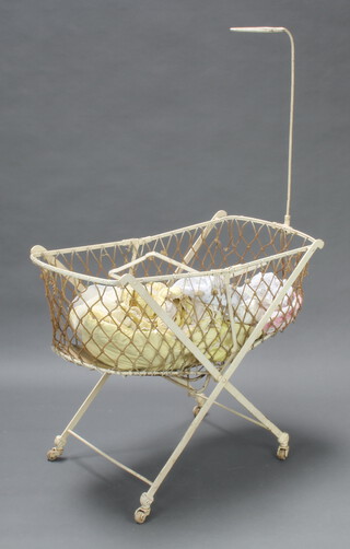 A Victorian oval metal folding crib 136cm x 89cm x 43cm, complete with brakes together with a Triang tubular metal and plastic dolls high chair 38cm h x 26cm w x 30cm d, a Sooty and Sweep hand puppet, a turned wooden jar and cover, 2 Inuit style dolls etc 