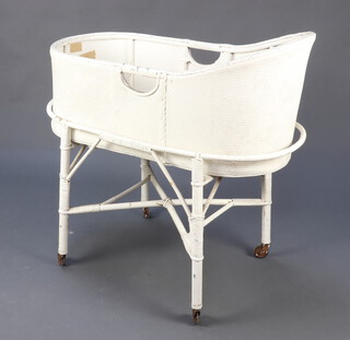 An oval white loom cradle 82cm h x 81cm w x 42cm d 