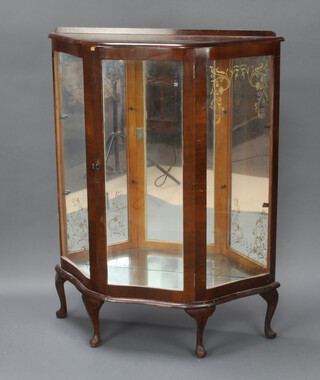 A 1950's walnut display cabinet with raised back, enclosed by a panelled door, raised on cabriole supports 114cm h x 89cm w x 29cm d 