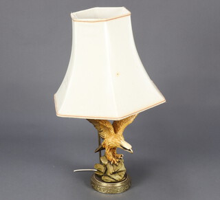 A resin table lamp in the form of an eagle raised on a gilt metal base 48cm h 