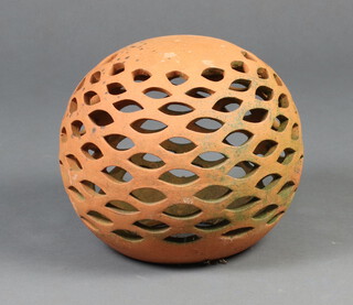 A pierced globular terracotta garden ornament 20cm h x 29cm 