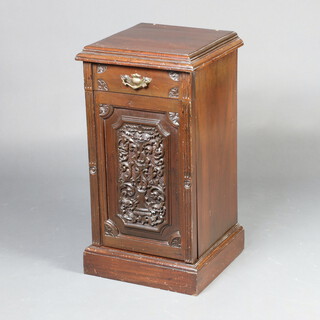 A Victorian carved mahogany bedside cabinet fitted a drawer above cupboard enclosed by a panelled door, raised on a platform base 80cm h x 42cm w x 41cm d 