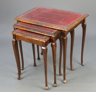 A nest of 3 Edwardian interfitting coffee tables with red inset tops, raised on cabriole supports 55cm h x 57cm w x 41cm d