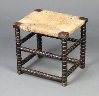 A Victorian bobbin turned stool with woven rush seat 35cm x 37cm x 31cm 
