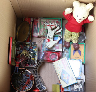 A articulated metal Muffin The Mule puppet, a rubber Rupert The Bear figure, various puzzles and toy money etc 