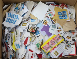 A quantity of Elizabeth II GB used stamps on paper together with a quantity of 1950's Meccano magazines