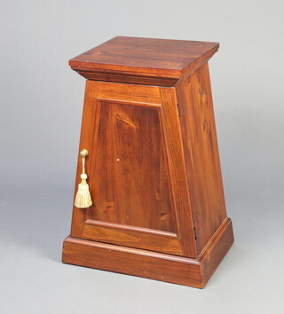 A Georgian style pyramid shaped cabinet enclosed by a panelled door, raised on a platform base 78cm h x 40cm w x 40cm d 