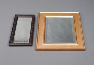 An Edwardian rectangular bevelled plate wall mirror contained in an oak frame 43cm x 21cm and 1 other in a gilt frame 55cm x 45cm 