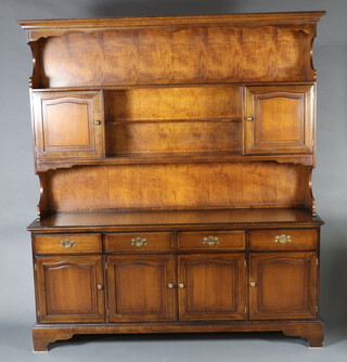 A Stag mahogany dresser with moulded cornice, fitted a shelf flanked by cupboards above recess, the base fitted 4 drawers above cupboards enclose by panelled doors, raised on bracket feet 197cm h x 175cm w x 46cm d 