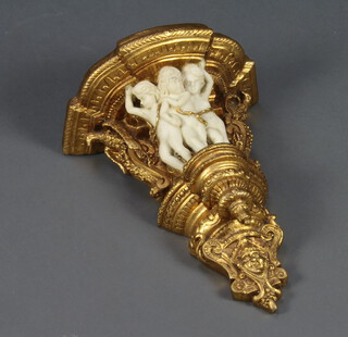 A gilt resin wall bracket supported by cherubs 18cm h x 43cm w x 32cm d 