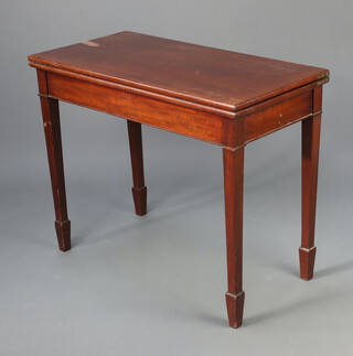 A Georgian style mahogany tea table raised on square tapered supports, spade feet, 74cm h x 92cm w x 46cm d (water marks and pitting in places) 