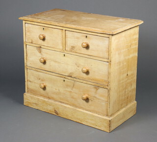 A 19th Century pine chest of 2 short and 2 long drawers with turned wooden handles, raised on a platform base 76cm h x 87cm w x 45cm d 