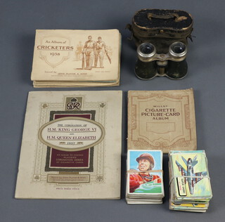 A pair of opera glasses with carrying case, 8 albums of cigarette cards and a collection of A&BC trade cards 
