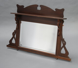 An Art Nouveau rectangular bevelled plate over mantel mirror contained in a shaped and pierced mahogany frame 82cm h x 94cm w x 15cm d (slight split to frame) 