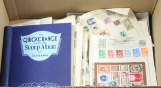 A blue album of used world stamps, a collection of first day covers and loose stamps 