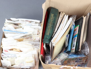 A collection of loose world stamps, some on paper and stamp album sheets, contained in a shallow box and 1 other  