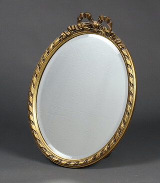 An oval bevelled plate wall mirror contained in a decorative gilt frame 53cm h x 39cm 