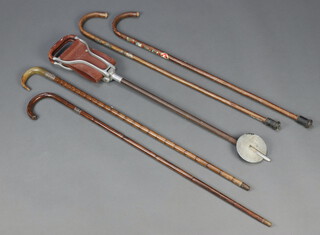 A walking stick with silver band and horn handle, 2 other walking sticks and a shooting stick 