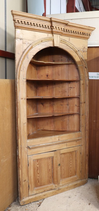 A 19th Century pine corner cabinet with moulded and dentil cornice, the upper section fitted 5 shelves, the base enclosed by a panelled door 222cm h x 121cm w x 85cm d 