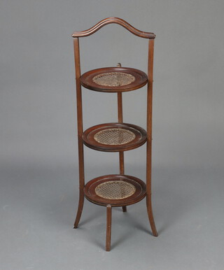 An Edwardian circular mahogany 3 tier cake stand with woven cane panels 88cm h x 25cm diam. (some wear to the cane) 