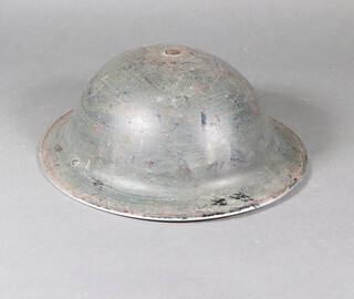 A British Second World War steel helmet complete with liner, no strap 12cm x 30cm  28cm 