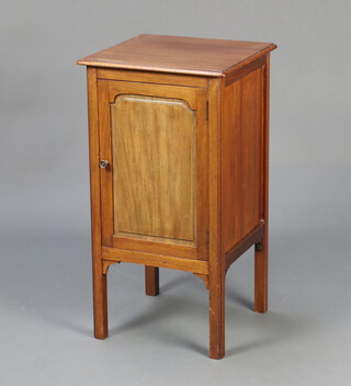 An Edwardian mahogany bedside cabinet enclosed by arched panelled door raised on scroll supports 70cm h x 38cm w x 36cm d 