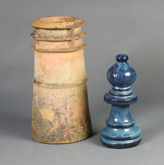 A blue glazed terracotta garden ornament in the form of a chess piece 36cm h x 14cm diam. together with a terracotta chimney pot 46cm h x 41cm diam. 