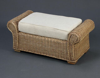 A wicker stool/window seat with scrolled arms and cushion 34cm h x 80cm w x 37cm d (2 small sections of damage to the left hand arm)  