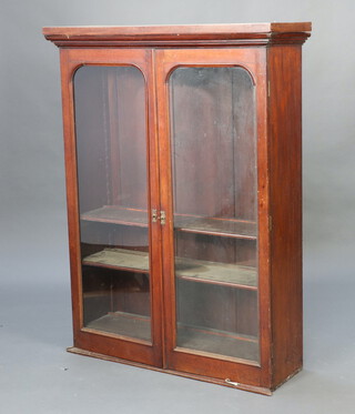 A Victorian mahogany bookcase top fitted shelves enclosed by arched glazed panelled doors 134 cm h 101cm w x 31cm d  
