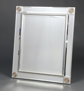 A rectangular bevelled plate wall mirror contained in a decorative frame with silver roundels 65cm x 55cm 