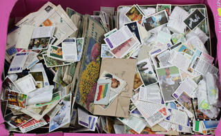 A collection of tea cards, trade cards etc, contained in a fruit box