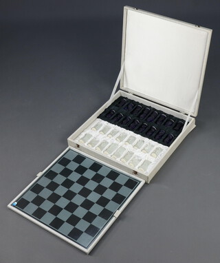 A Czechoslovakian glass chess board together with clear and blue glass chess pieces, contained in a presentation case 7cm h x 46cm w x 46cm d 