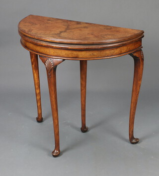 A 1930's Queen Anne style figured walnut tea table raised on cabriole supports 78cm h x 83cm w x 41cm d (the top is warped) 