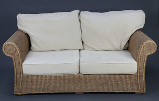A wicker 2 seat conservatory sofa with upholstered loose cushions 86cm h x 187cm w x 87cm d and a matching armchair 80cm h x 95cm w x 67cm d 