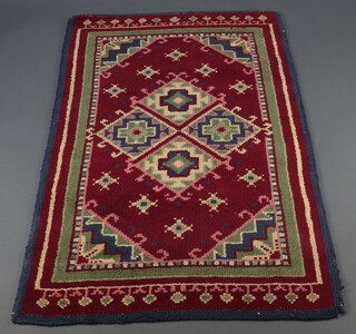 A 1930's red and green ground rug 157cm x 91cm 