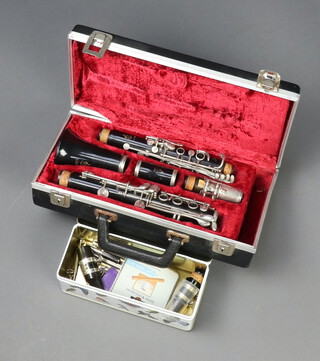 A Regent clarinet boxed and a rectangular metal tin containing various accessories 