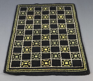 A black and gold ground rag style rug 136cm x 91cm 