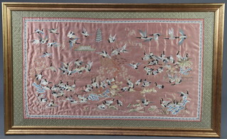 An early 20th Century Chinese silk embroidery of a group of exotic birds 61cm x 106cm