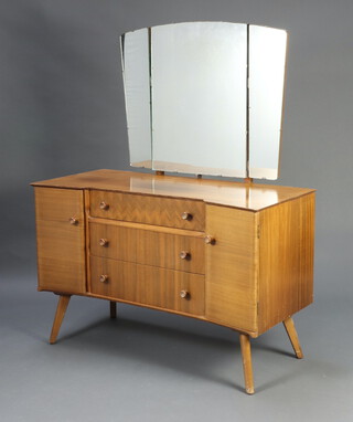 A mid-Century teak dressing chest of shaped outline with triple mirror above 3 drawers flanked by cupboards, raised on outswept supports 143cm h x 117cm w x 52cm d (some sun bleaching)  