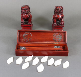 A pair of composition figures of shi shi 17cm, a hardwood box containing chopsticks and rests  