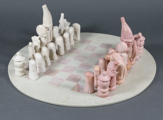 A hardstone circular chessboard and chess set 