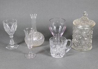A cut glass biscuit barrel and cover 23cm, a decanter, 3 glasses and a mug 